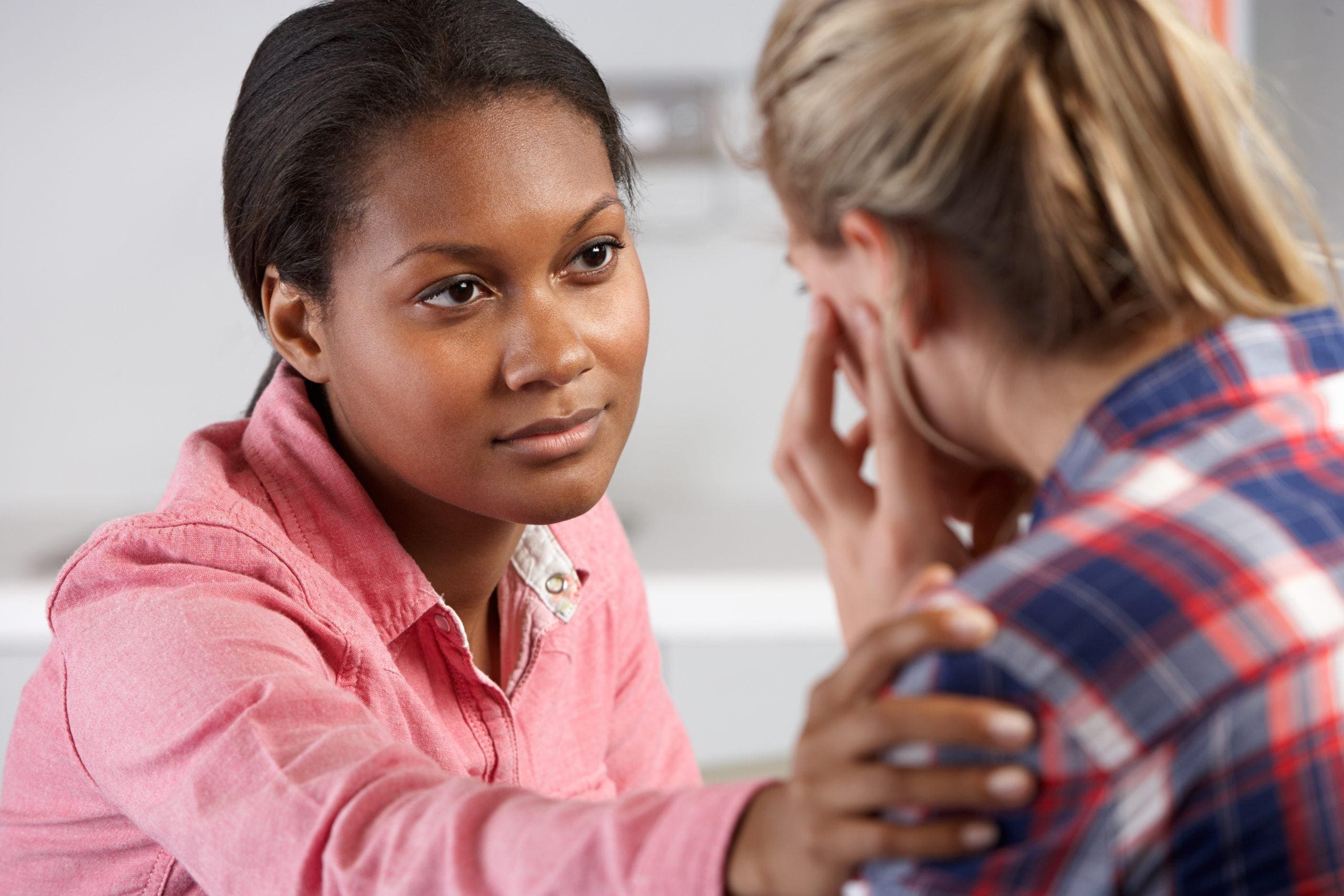 An image of a woman offering mental illness help to a friend