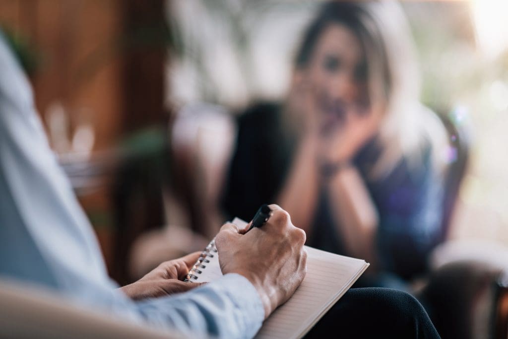 A behavioral health specialist working with a patient.