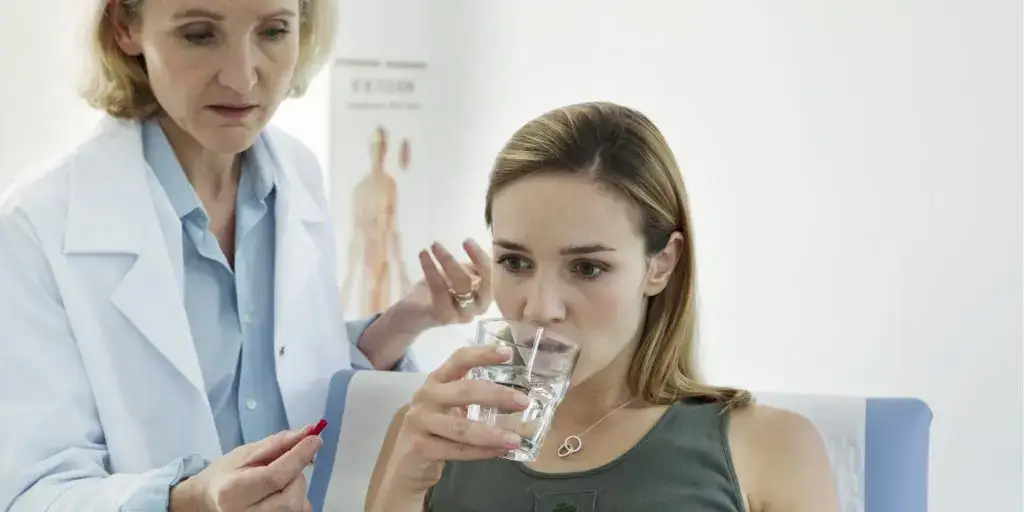 Doctor handling pill for a patient