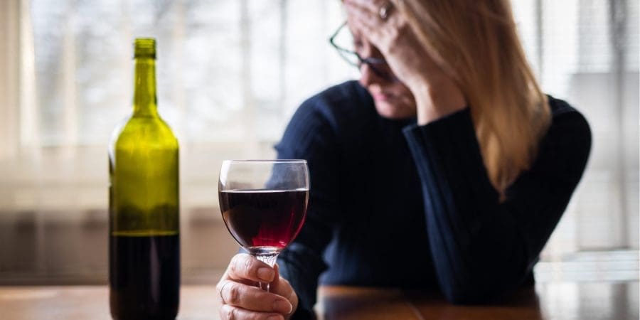 woman drinking alcohol worrying about relationship
